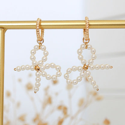 Coquette Bow Earrings Pearlized Glass & 24K Gold-Plated Hoops - The perfect flirtatious finish.